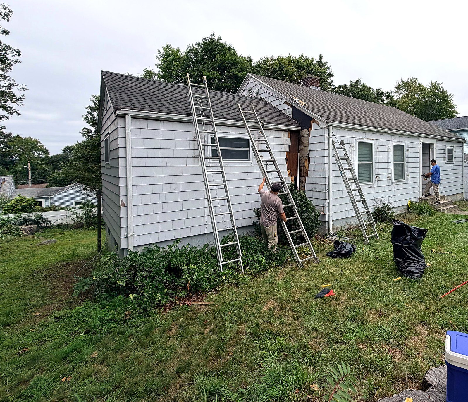 Maverick City Builders crew on ladders at the dormer of a Worcester, MA cape during exterior rot repair