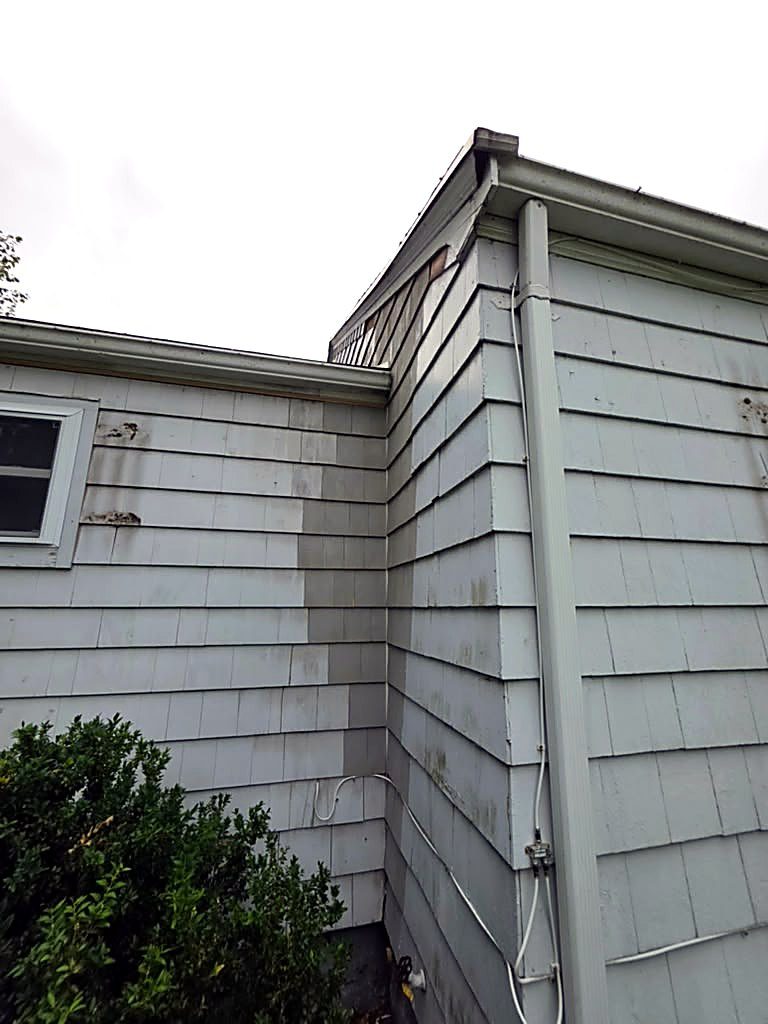 Inside corner where a dormer wall meets the main slope on a Worcester, MA home, with the corner board and shingles failing before work started