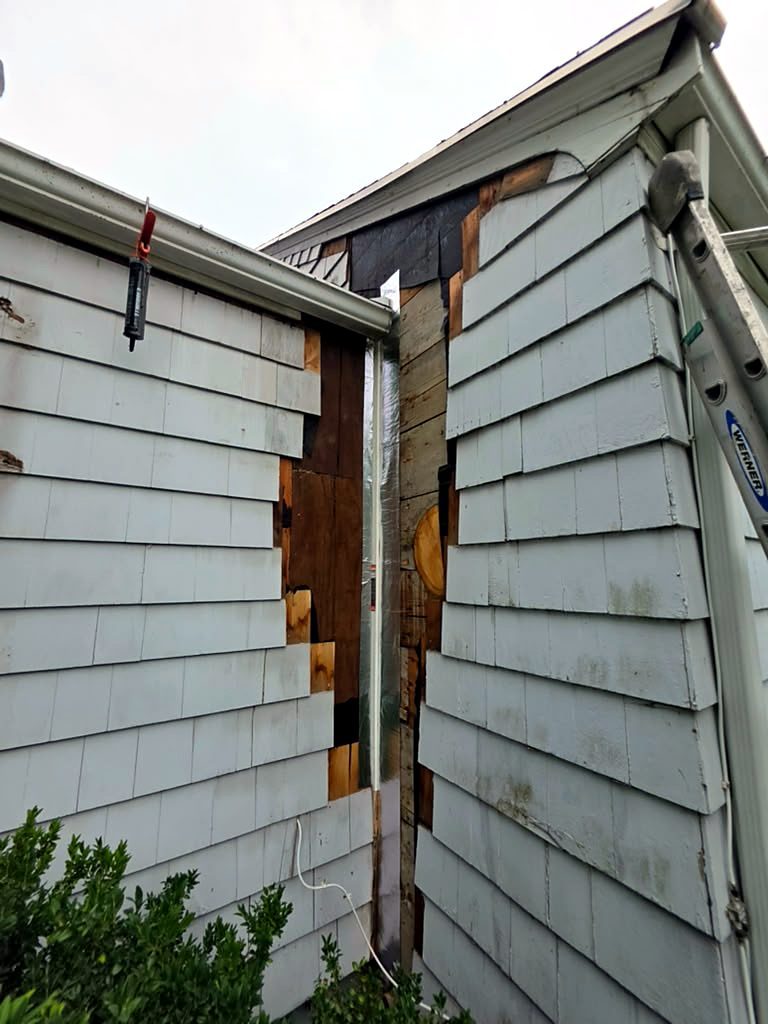 New plywood sheathing and flashing tape installed at the repaired corner on a Worcester, MA cape before the shingles go back on