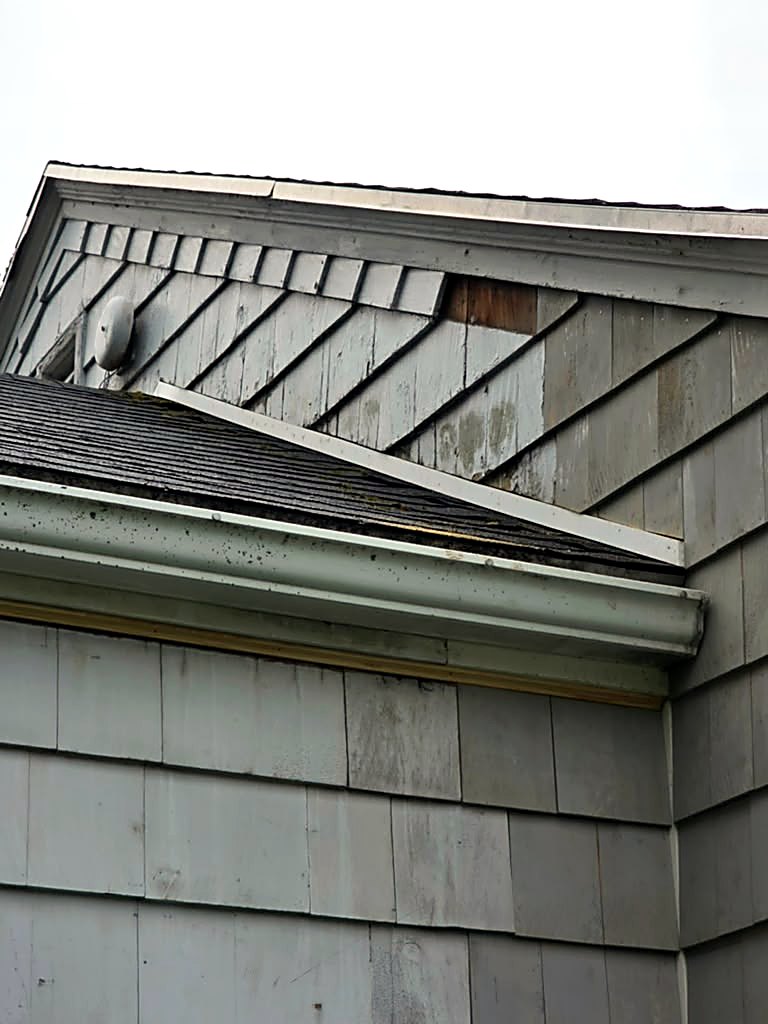 Before: weathered gable shingles on a Worcester, MA cape ahead of siding and rot repair