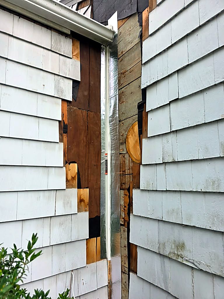 During: siding removed and wall sheathing exposed on a Worcester, MA cape