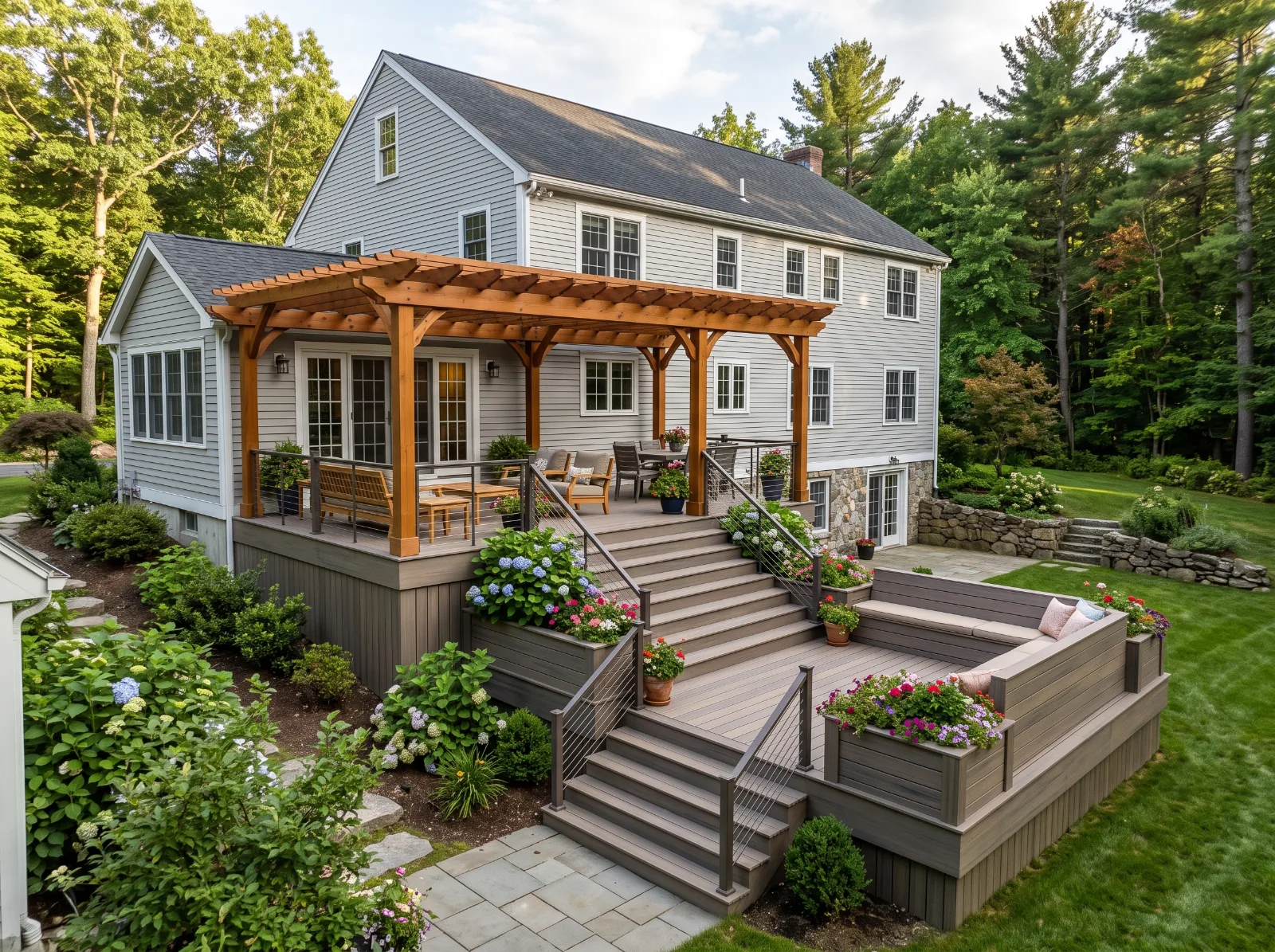 Design idea: two-level composite deck stepping down a sloped backyard with an open-top wood pergola over the upper level